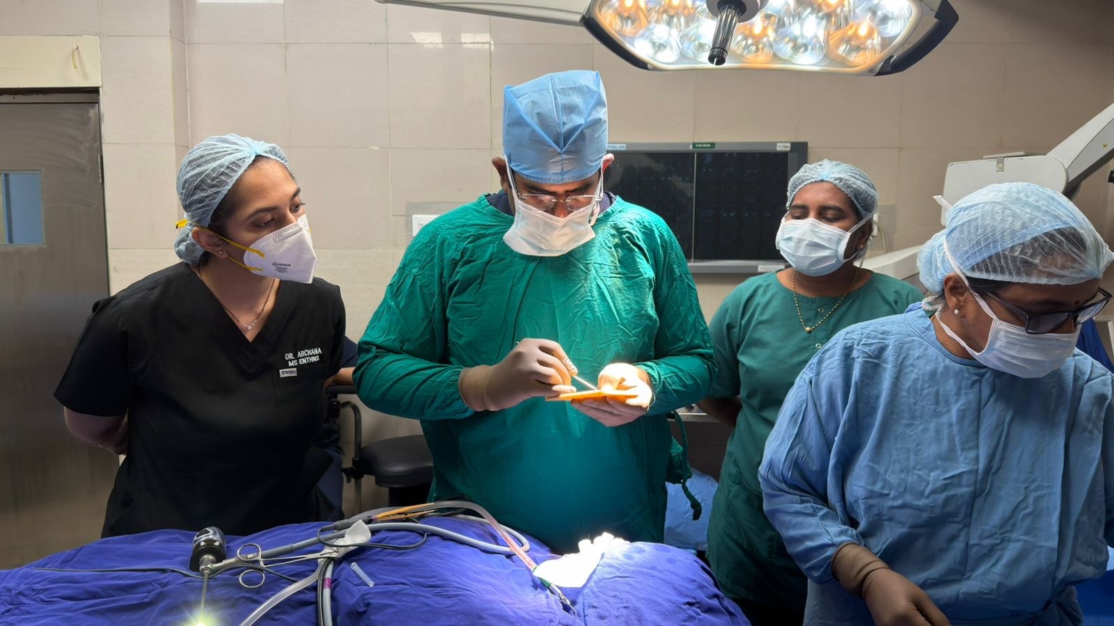 Dr. Manusrut performing ENT surgery with his team